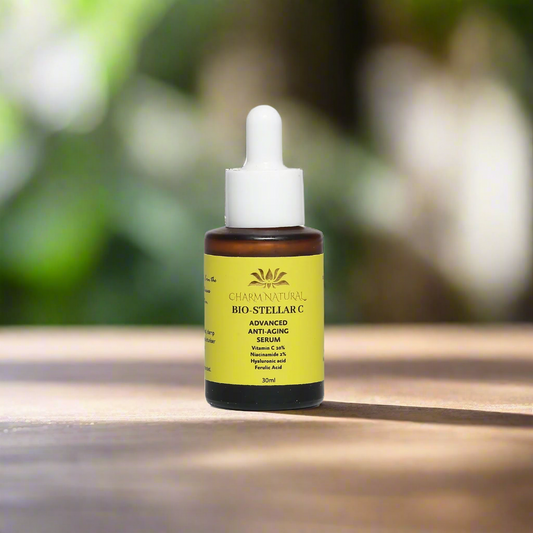 Bottle of Chiam Naturals Bio-Stellar C serum on a wooden surface with a blurred green background